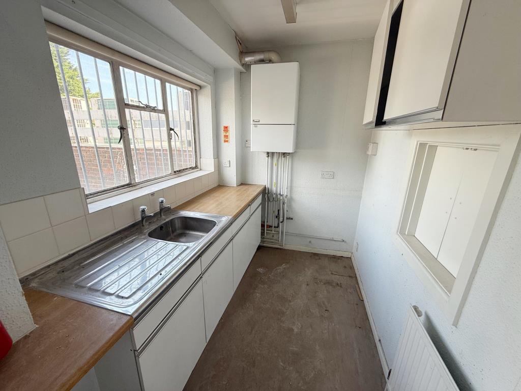 Lot: 109 - FIRST AND SECOND FLOOR THREE-BEDROOM MAISONETTE - Kitchen with fitted cupboards and wall mounted boiler